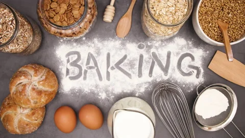 Baking ingredients moving around baking title written on flour - Stop motion 動画素材 131399998