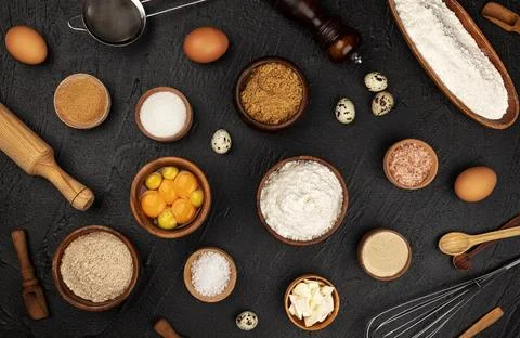 Baking ingredients pattern on black background, top view Stock Photos