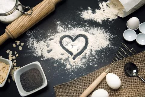 Baking love. Bakery background. Baking ingredients and kitchen utensils on .. Stock Photos