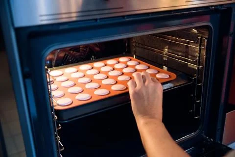 Baking macarons in the oven Stock Photos