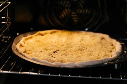 Baking making pizza with cheese in an electric oven Stock Photos