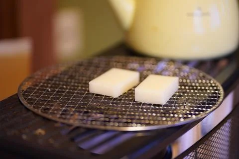 Baking mochi on the stove Stock Photos