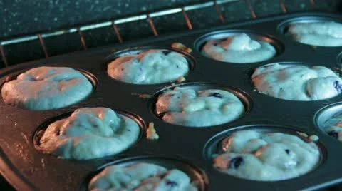 Baking muffins in the oven, watch them rise. Stock Footage 20528196