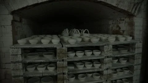 Baking oven. A rack of baked earthenware dishes is rolled out of the oven. Video stock 130526421