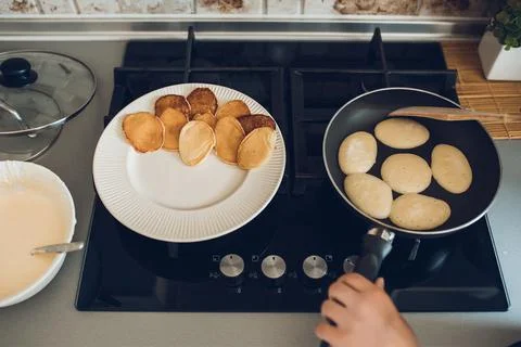 Baking pancakes in modern kitchen. Steps of making cooking pancake at home. Stay Stock Photos