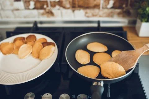 Baking pancakes in modern kitchen. Steps of making cooking pancake at home. Stay Stock Photos