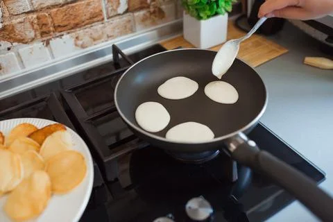 Baking pancakes in modern kitchen. Steps of making cooking pancake at home. Stay Stock Photos