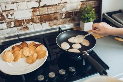 Baking pancakes in modern kitchen. Steps of making cooking pancake at home. Stay Stock Photos