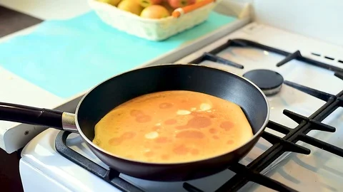 Baking pancakes in a pan. flip the pancake on the pan with a fork Video stock 105395876