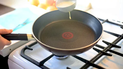 Baking pancakes in a pan. flip the pancake on the pan with a fork Video stock 105396043