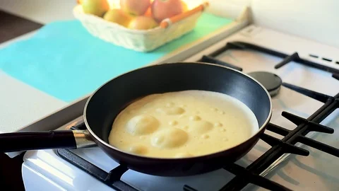 Baking pancakes in a pan. flip the pancake on the pan with a fork Video stock 105396140