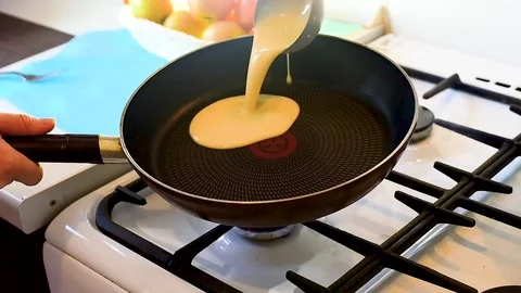 Baking pancakes in a pan. flip the pancake on the pan with a fork Video stock 105396255