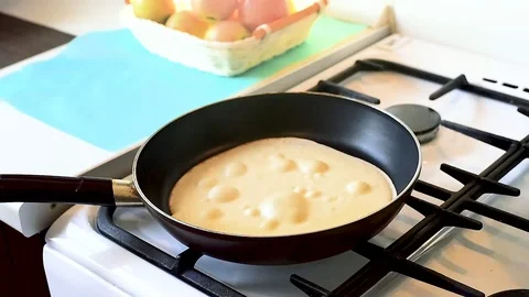 Baking pancakes in a pan. flip the pancake on the pan with a fork Video stock 105396376