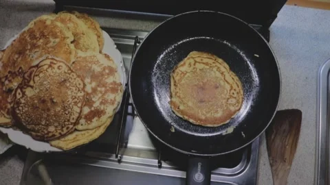 Baking pancakes;  shot from above Stock Footage 231872437