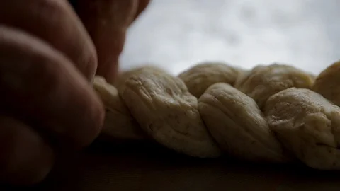 Baking pastry at a bakery. Close up of a chef twisting raw bread dough. Stock Footage 92382144