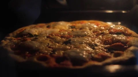 Baking pizza in the oven with bubbling cheese Stock Footage