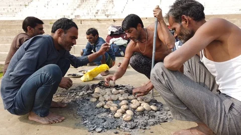Baking potatoes on Varanasi Ghat Stock Footage 116551950