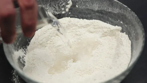 Baking preparation: mixing flour and sugar with water Stock Footage 233815901