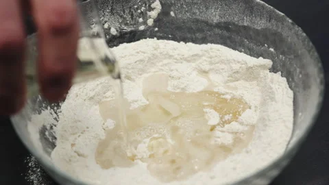 Baking preparation: mixing flour, sugar with water and vegetable oil Video stock 234521735