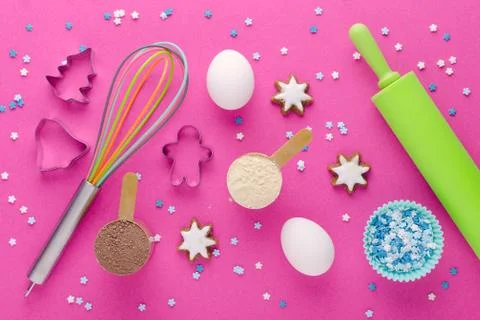 Baking protein, eggs and kitchen tools with cookie cutter on pink background Stock Photos