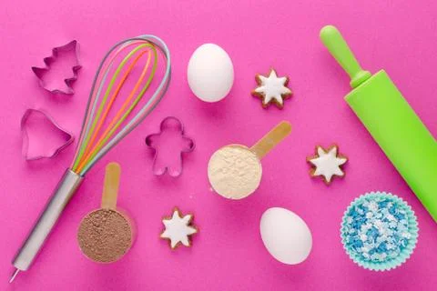 Baking protein, eggs and kitchen tools with cookie cutter on pink background Stock Photos