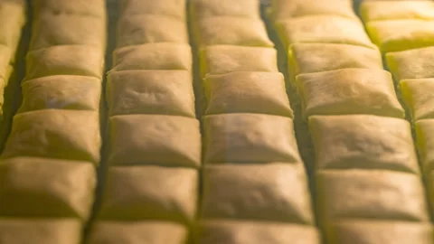 Baking puff pastry parcels filled with basil pesto and cheese - Timelapse Stock Footage 260230788