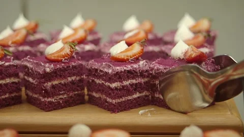 Baking a purple cake with strawberries and cream on top Stock Footage 346739293