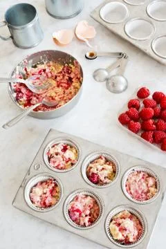Baking Raspberry Muffins or Cupcakes, Filling Tins with Batter Stock Photos