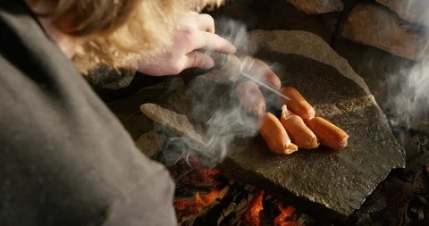Baking sausages on fire grill campfire Stock Footage 90404250