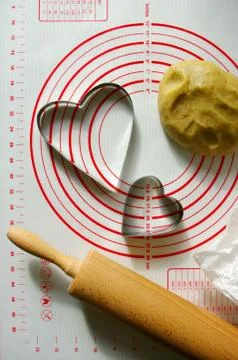 Baking scenery with heart shaped cookie cutter, rolling pin for dough, silico Stock Photos
