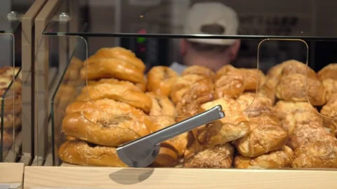 Baking scenes capture attention as fresh Baking emerges close-up with worker Stock Footage 274500051