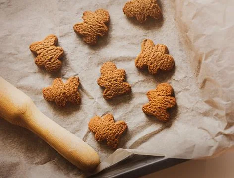 On a baking sheet on baking paper are oatmeal homemade cookies in the form of Stock Photos
