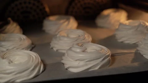 Baking sheet with white meringues stand and cook in the oven. Cooking Stock Footage 250170256