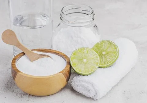 Baking soda and lime on a rustic surface Stock Photos