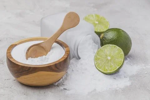 Baking soda and lime on a rustic surface Stock Photos
