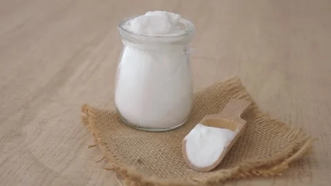 Baking soda powder in a container on a table for cleaning Stock Footage 343707187