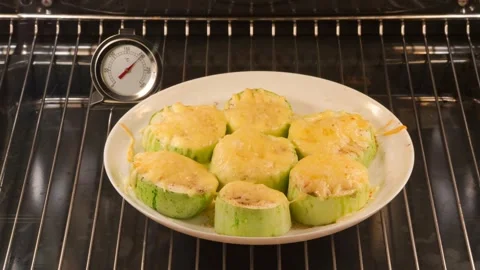 Baking of squashes with grated cheese in oven Video stock 141809478