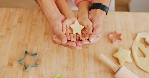 Baking, star and hands of child with parent in kitchen for learning, help and Stock Photos