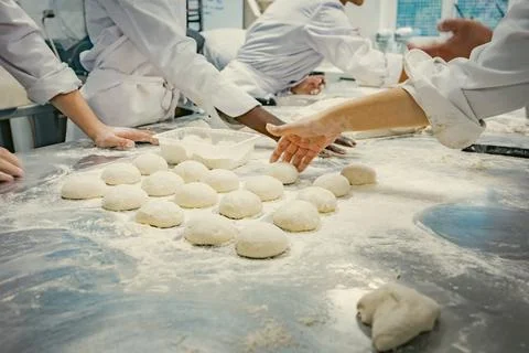 Baking students preparing fresh dough in a professional kitchen Stock Photos