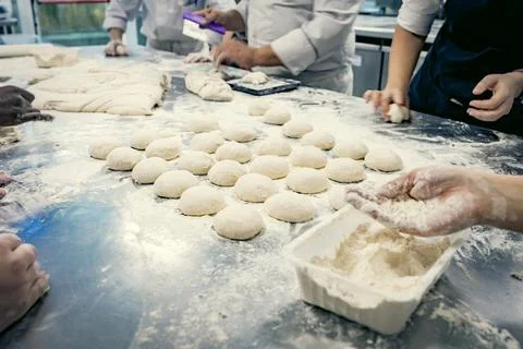Baking students preparing fresh dough in a professional kitchen Stock Photos