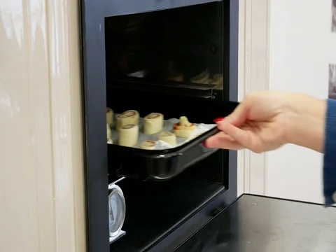 Baking of sweet rolls in an old kitchen oven Stock Footage 80840873