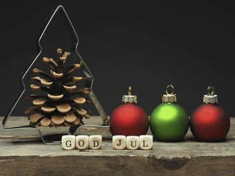 Baking tin tree shape with small wooden dices and the words God Jul, Stock Photos