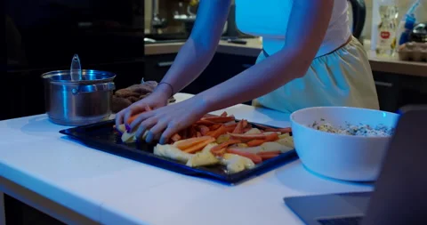 A baking tray with fresh vegetables, potatoes and carrots. Slow motion. Stock Footage 146606874