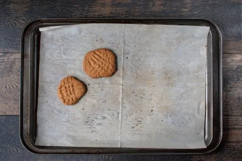 Baking tray with white parchment with two Peanut butter cookies Foto stock