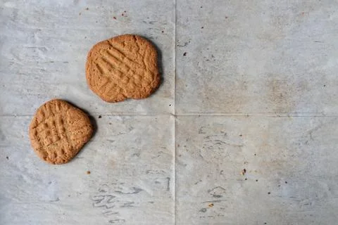 Baking tray with white parchment with two Peanut butter cookies Stock Photos