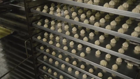 Baking trays getting filled with cookie dough in food factory. Stock Footage 284210940