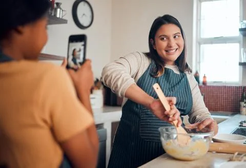 Baking, tutorial and social media with a chef woman in the kitchen of her home Foto stock