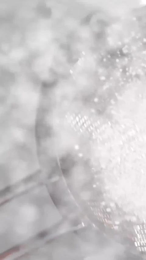 Baking tutorial showcasing the sifting of flour with a fine mesh strainer in a Stock Footage 316795998