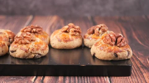Baking walnut cookies in a kitchen setting Stock Footage 330036604