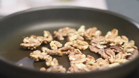 Baking of walnuts in a pan. Stock Footage 159872394